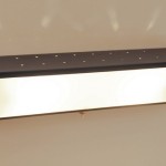 Large black lacquered perforated wall light with perspex by Jacques Biny